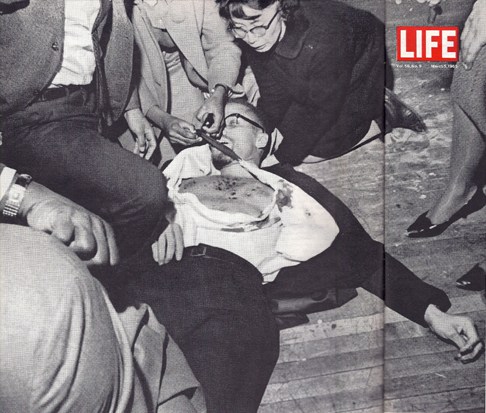Yuri Kochiyama in photo with Malcolm X after he was shot.