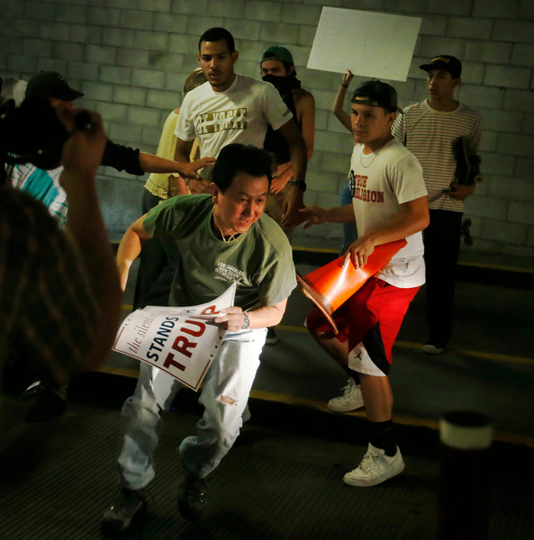 Protesters harass a Trump supporter in the San Jose Convention Center parking garage as Presidential candidate Donald Trump holds a rally in San Jose, Calif., Thursday, June 6, 2016. (Patrick Tehan/Bay Area News Group)